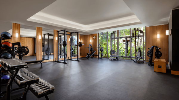 clean fitness studio with new workout equipment and jungle views